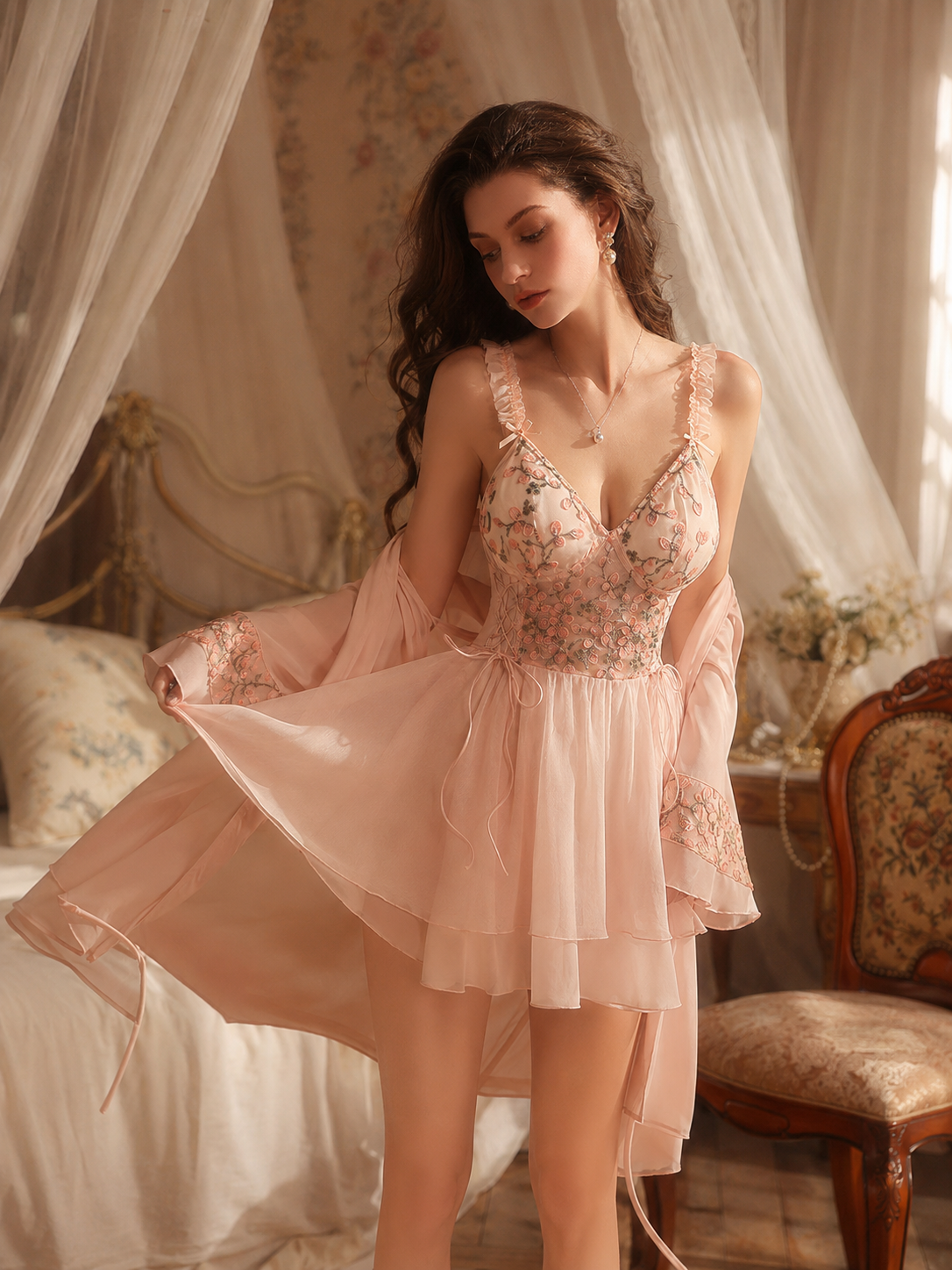 Model wearing Soft Noir blush pink floral embroidered nightgown and robe set in a romantic bedroom