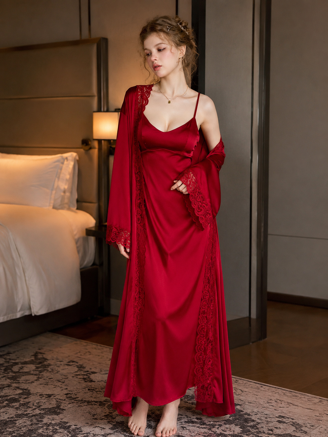 Model wearing Soft Noir crimson red satin slip dress with lace robe in hotel bedroom