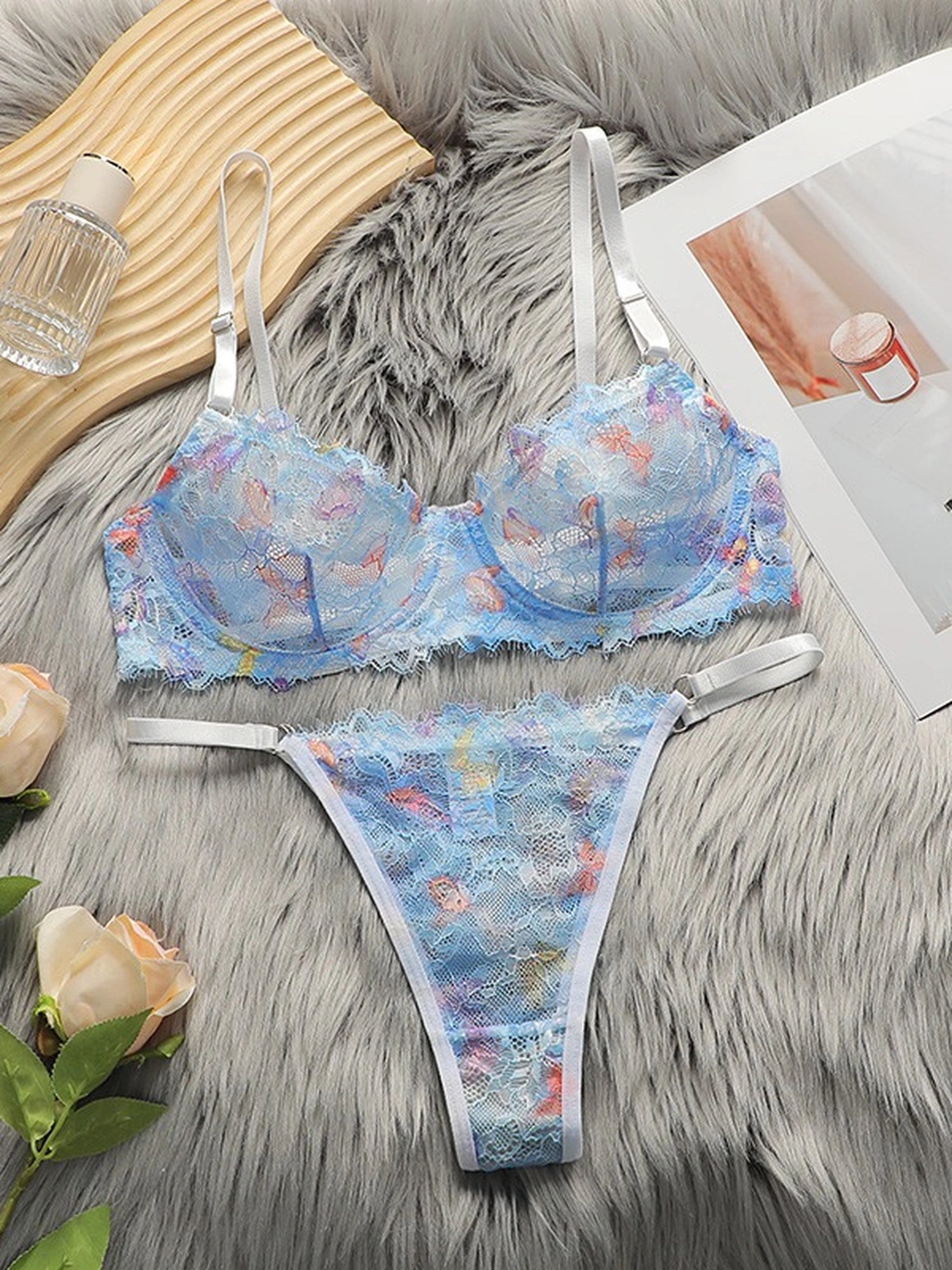 Soft Noir pastel blue sheer lace bra and thong set flat lay