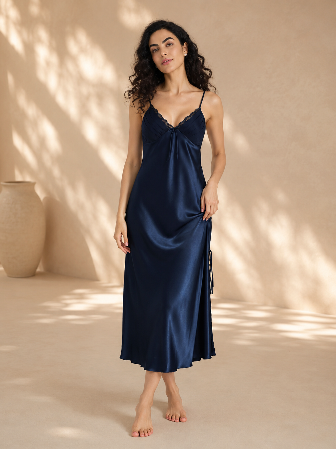 Model wearing midnight navy satin slip nightgown with pleated cups