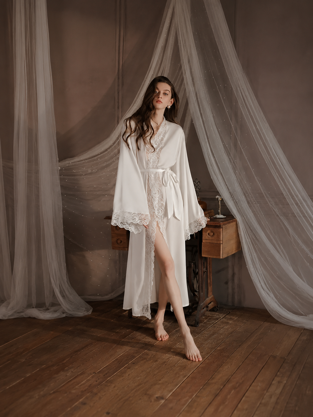 Model wearing Soft Noir white satin lace long robe for bridal sleepwear styling